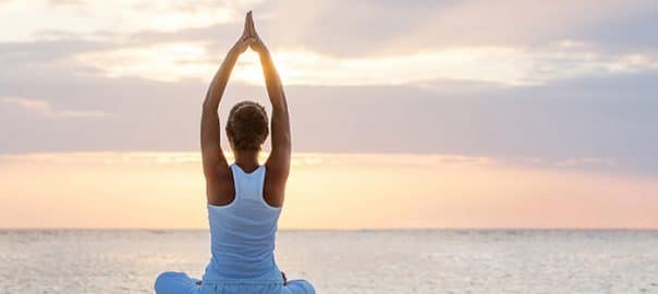 woman doing yoga 604x270 1