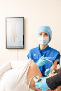 Dr. Danielle Aufiero performing stellate ganglion block therapy on a patient to reduce chronic pain